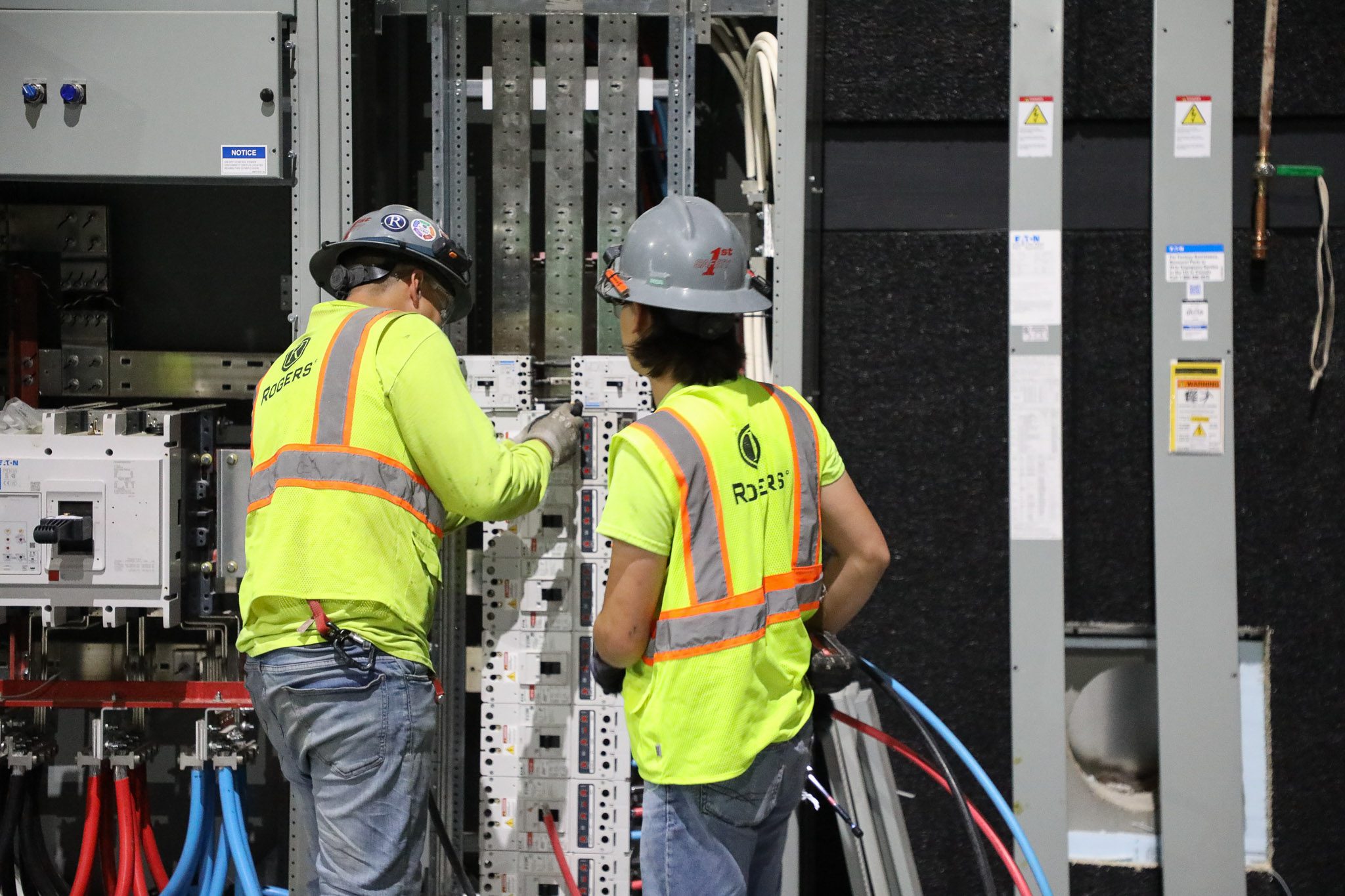 Rogers technicians working on electrical box.