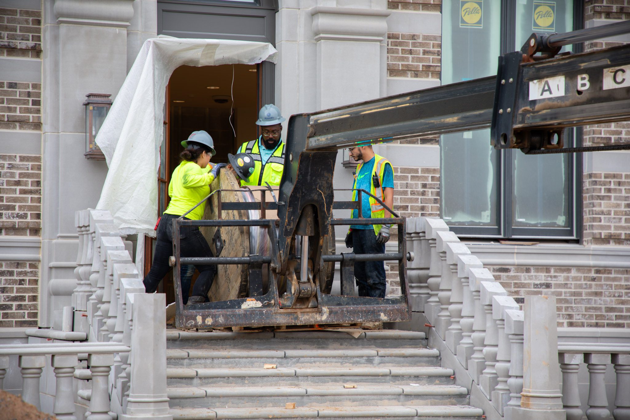 Rogers technicians preparing to install fixtures using a lift.