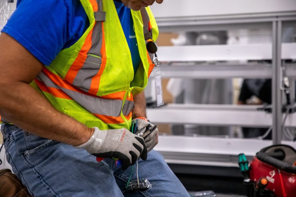 zoomed in picture of electrician hands working on outlet wires