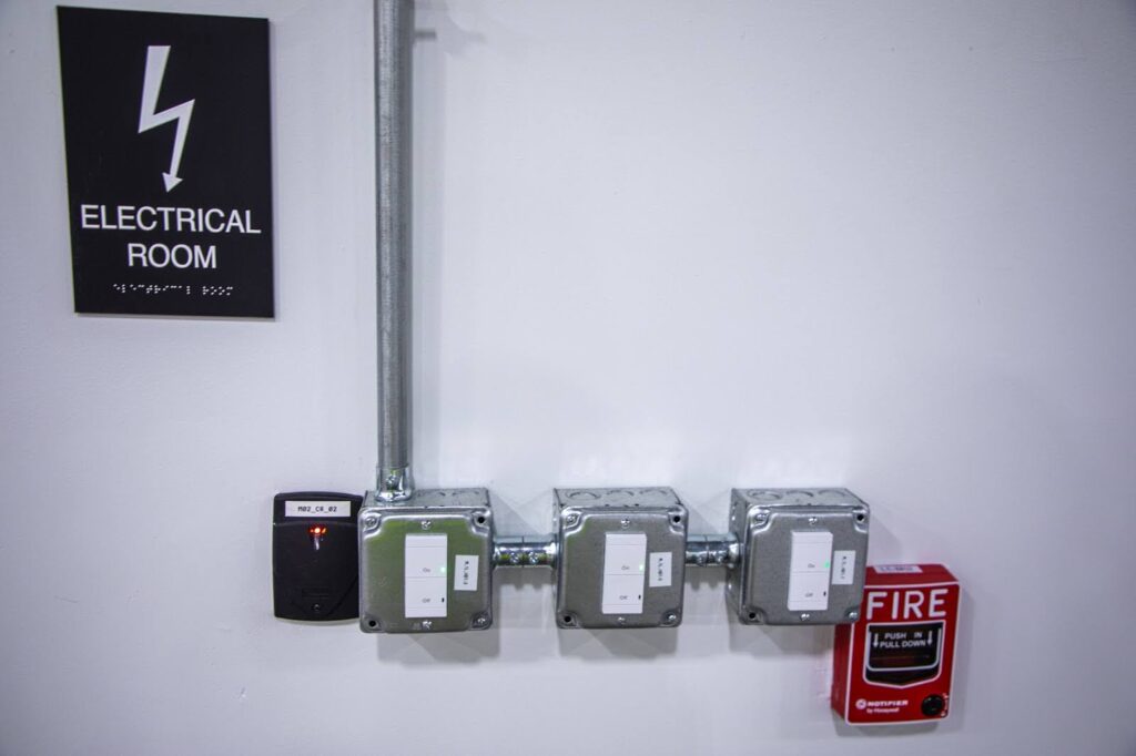 three outlets and an electrical room sign